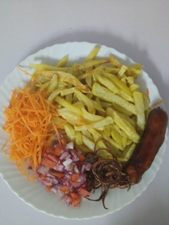 A picture of Home made fries with onion rings and Kachumbari.