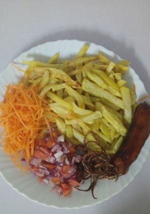 A picture of Home made fries with onion rings and Kachumbari.