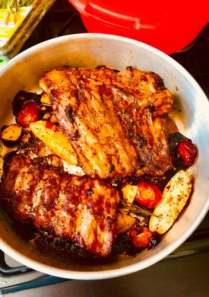 A picture of Bbq Spare Ribs with potatoes And Cherry Tomatoes.
