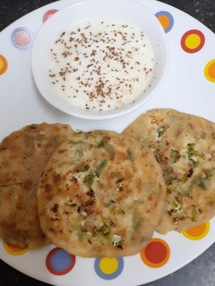 A picture of Paneer Paratha with Spring Onions.