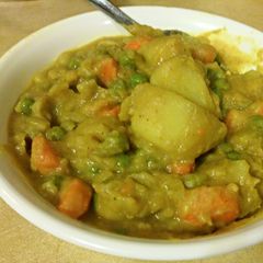 A picture of Curry Potatoes with Peas and Carrots.