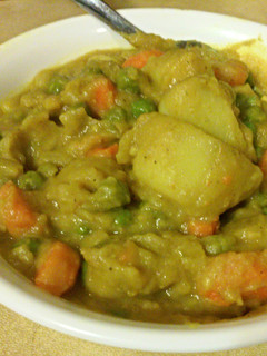 A picture of Curry Potatoes with Peas and Carrots.