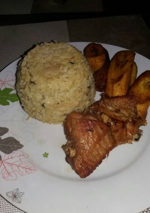 A picture of Curry rice with fried chicken and plantain.