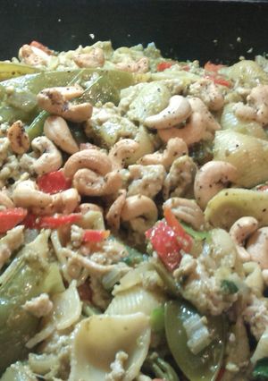 A picture of Chicken.pesto.pasta.with cashews and parmesan.