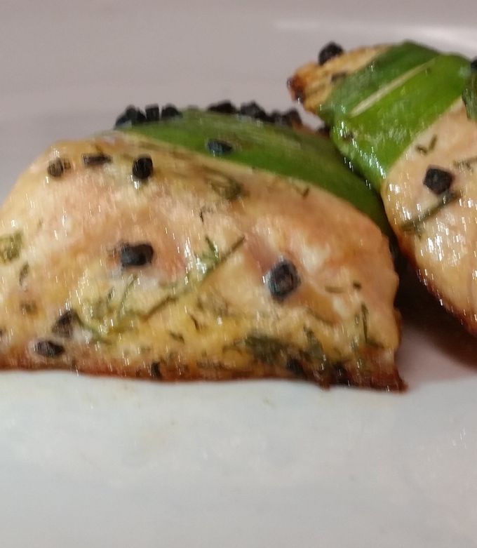 A picture of leek wrapped salmon w black hawaiian sea salt.