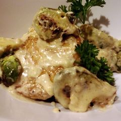A picture of Sauteed pork and brussels sprouts in cream sauce.