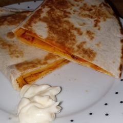 A picture of My cheese and cherry tomato quesadilla.