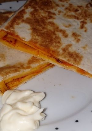 A picture of My cheese and cherry tomato quesadilla.