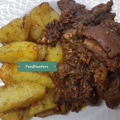 A picture of Peppered GOAT meat and potatoes.