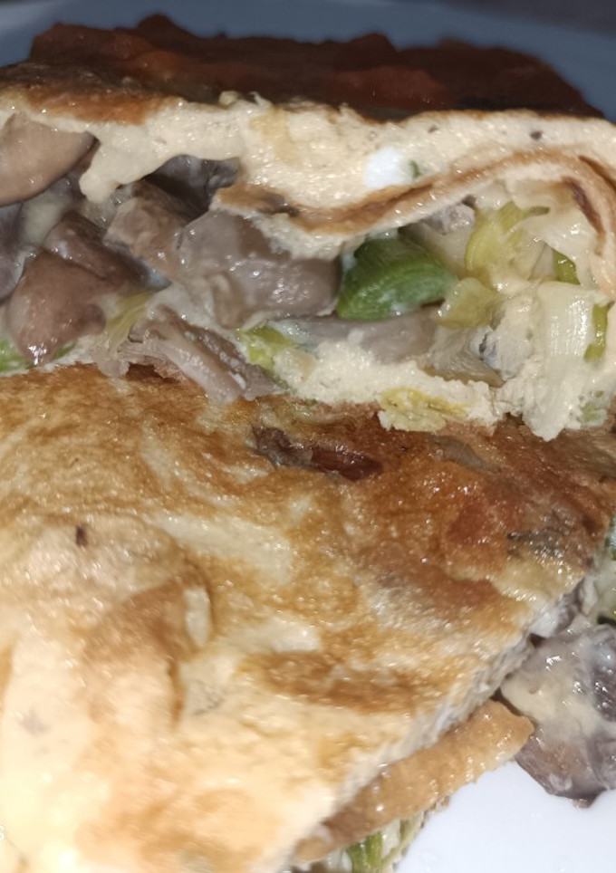 Una foto de "Calzone" de huevo con ajos tiernos y setas