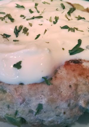 A picture of Greek Turkey Burgers with Avocado and a Lemon Parsley Mayo.