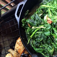 A picture of Skillet Spinach Over An Open Fire.