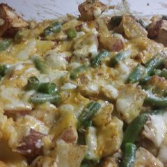 A picture of Chicken tator tot casserole with red potatoes and green beans.
