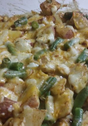 A picture of Chicken tator tot casserole with red potatoes and green beans.