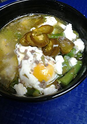 A picture of Sausage, asparagus, and egg soup.