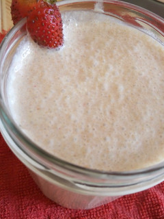 A picture of Milk shake with leftover cake crumbs.