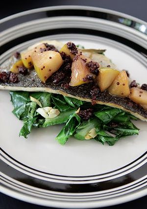 A picture of Sautéed Trout Filet Topped with Apple Mostardo and Garlicky Collard Greens.