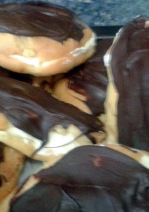 A picture of Cream puffs or chocolate eclairs.