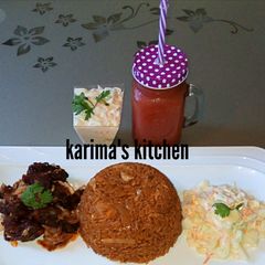 A picture of Jollof rice/peppered beef and coleslaw.