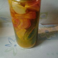 A picture of Pickled onions, garlic and cucumbers.