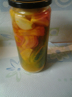 A picture of Pickled onions, garlic and cucumbers.