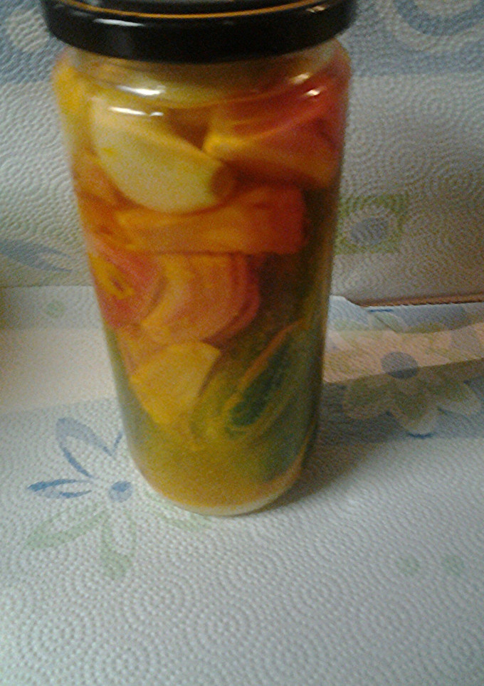 A picture of Pickled onions, garlic and cucumbers.