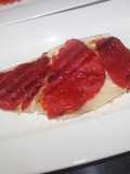 Lubina con beicon y pimientos