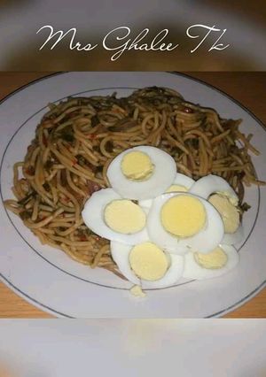 A picture of Pasta jallof with cooked eggs.