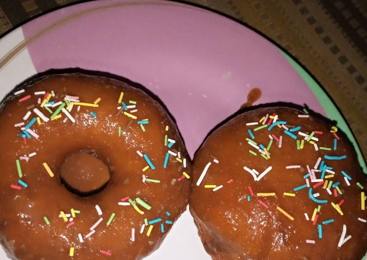 Doughnut wit melted chocolate and sprinkles