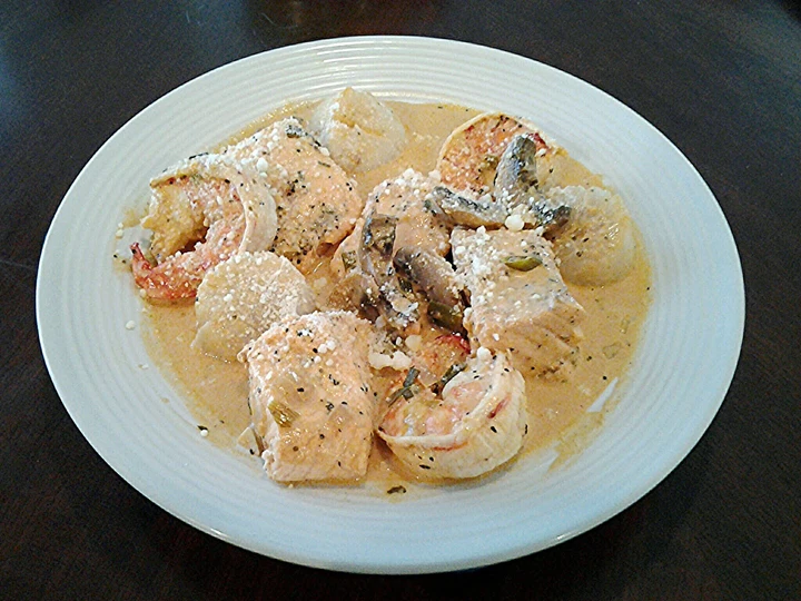 Recipe Salmon, Shrimp and Scallops poached in a Tomato Cream Broth the So Delicious So Delicious