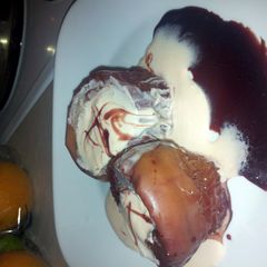 red wine poached apples with a honey cherry cheese cake maskotto cream A picture of red wine poached apples with a honey cherry cheese cake maskotto cream.