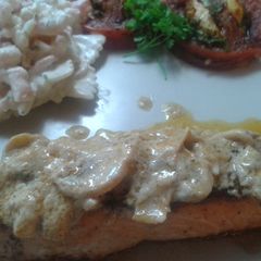 A picture of Steak salmon in mushroom white wine sauce.