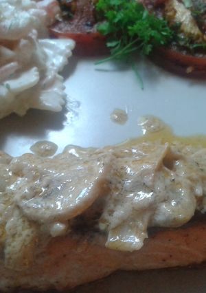 A picture of Steak salmon in mushroom white wine sauce.