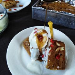 A picture of Dates pudding with toffee sauce.