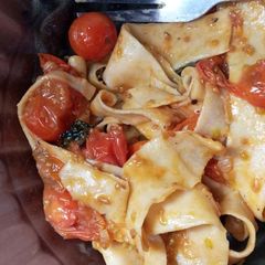 A picture of Homemade pasta with cherry tomatoes sauce.