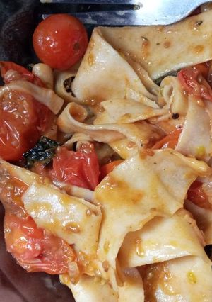 A picture of Homemade pasta with cherry tomatoes sauce.