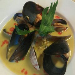 A picture of Smoked mussel and saffron soup.