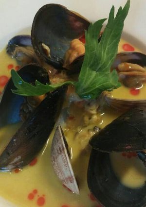 A picture of Smoked mussel and saffron soup.