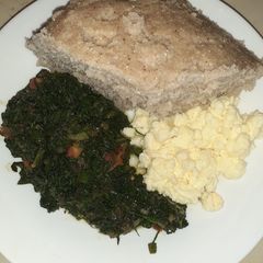 A picture of Scrumbled eggs, spinach and brown ugali.