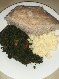 A picture of Scrumbled eggs, spinach and brown ugali.