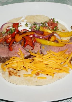A picture of FAJITAS WITH GRILLED BEEF AND PEPPERS. JON STYLE.