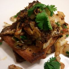 A picture of Sardines on fried toast.