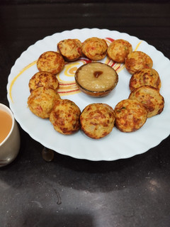 A picture of Moong Dal Appe with vegetables.
