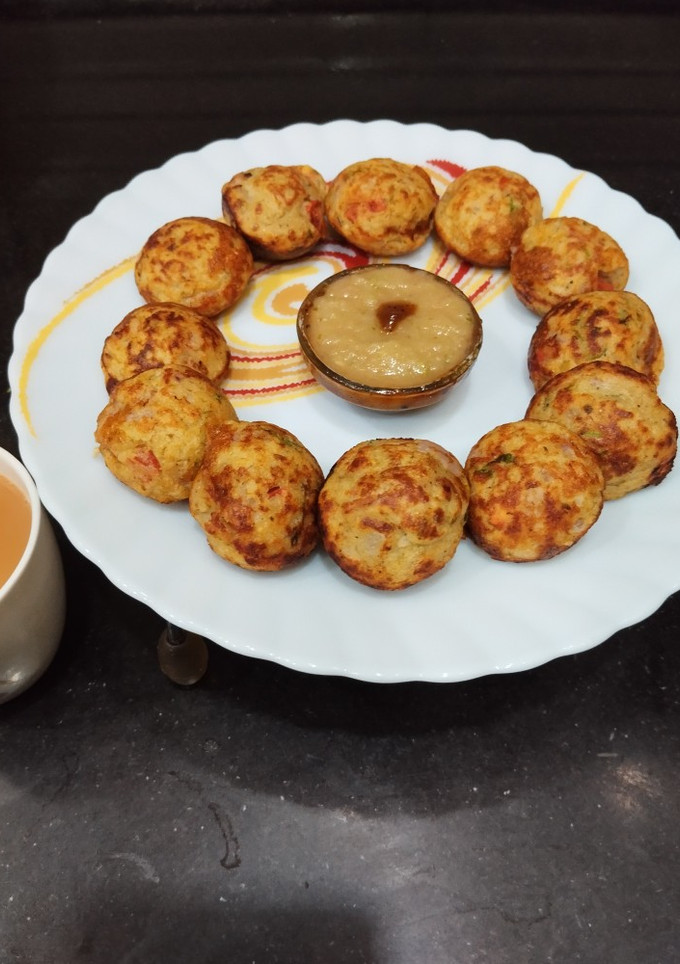 A picture of Moong Dal Appe with vegetables.