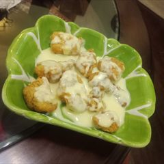 A picture of Chicken Tenders with cheese sauce.