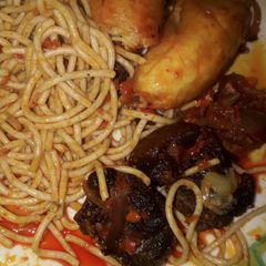 Palm oil spaghetti with unfried plantain and beef A picture of Palm oil spaghetti with unfried plantain and beef.