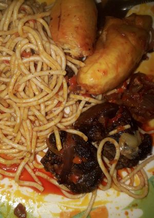 A picture of Palm oil spaghetti with unfried plantain and beef.