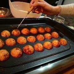 Perfectly Round Takoyaki With Crisp Outsides and Creamy Insides A picture of Perfectly Round Takoyaki With Crisp Outsides and Creamy Insides.