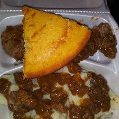 A picture of Homemade mashed potatoes w/ brown gravy hamburgers & cornbread!.