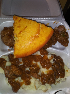 A picture of Homemade mashed potatoes w/ brown gravy hamburgers & cornbread!.